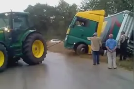 大货车掉沟里去了，拖拉机仗义援手，看看是怎么拉上去的吧!图片