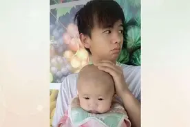 28岁的爸爸抱着6月大女儿，网友：爸爸好年轻，看起来像哥哥图片
