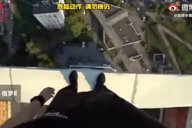 惊魂一刻！俄男子跑酷脚滑摔下房顶死里逃生，侥幸抓住电线狂喘气图片