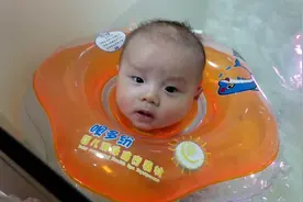全家带三个月宝宝去洗澡，小家伙第一次游泳还挺得劲