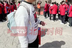 4月3日，山东泰安。电影《亲爱的》原型、寻子家长#杜小华爬泰山祈祷早日找到儿子  。遇见过成人礼的学生，他不由驻足观望：看到天真烂漫的孩子都会羡慕，会忍不住想小米奇是否在其中。（记者：蒋林君）