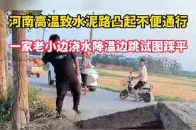 河南高温致水泥路凸起不便通行，一家老小边浇水降温边跳试图踩平