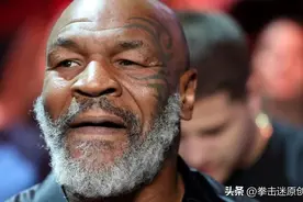 拳王泰森精神焕发，妻子身着豹纹长裙，两人十分具有夫妻相图片