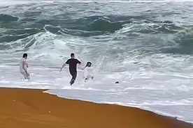 白衣小哥多次冲入巨浪救起小女孩 当事人：当时只想着救人 谢谢大家的赞美图片